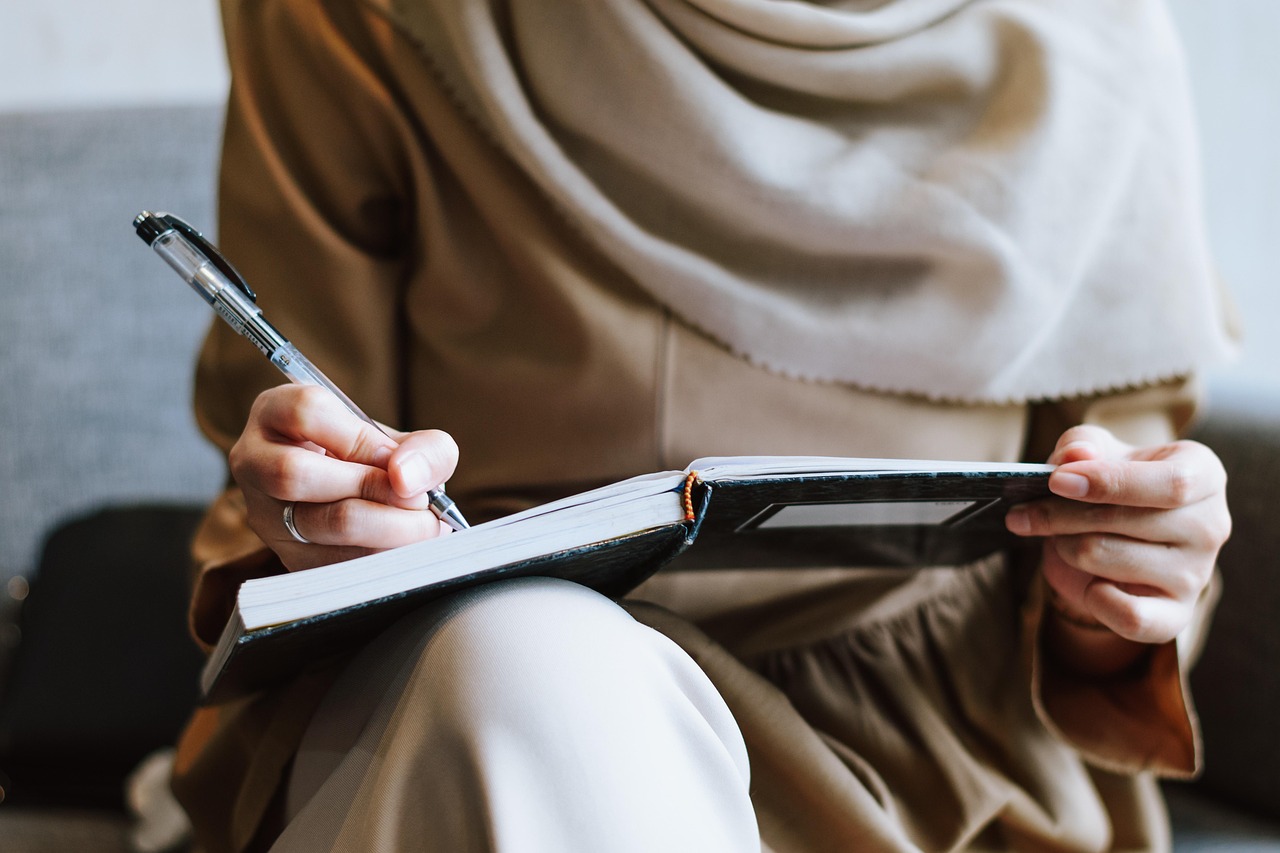 Person writing in notebook